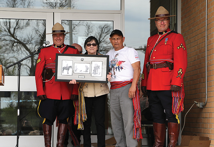 Left: Corporal Brett Church and Staff Sargent Matt Lavallee gifted a traditional RCMP Print to Leah LaPlante and Terry Haney of MMFS. The back of the gift states,Presented to MMFS Fort-Ellice local in recognition for your continued support and partnership with Prairie Mountain RCMP, thank you.